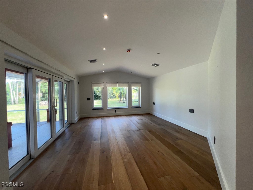 13191 Idylwild Farm Road Fort Myers, FL 33905 - Photo 16 of 21 a view of an empty room with wooden floor and a window