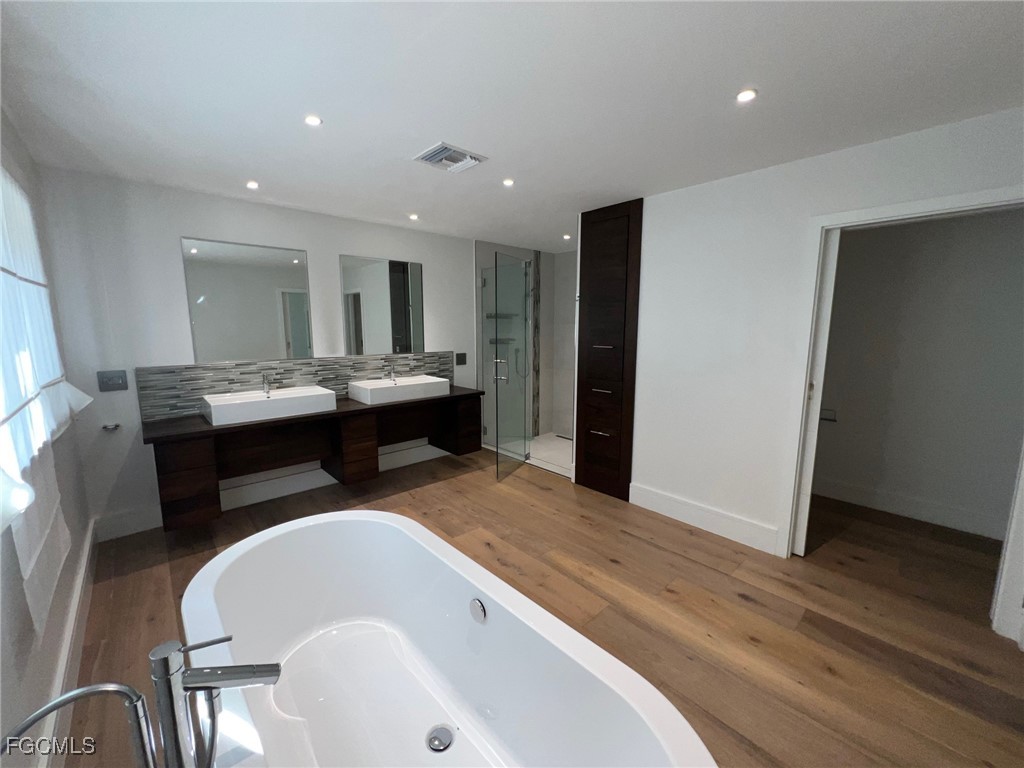 13191 Idylwild Farm Road Fort Myers, FL 33905 - Photo 19 of 21 a dining hall with granite countertop white cabinets and wooden floor