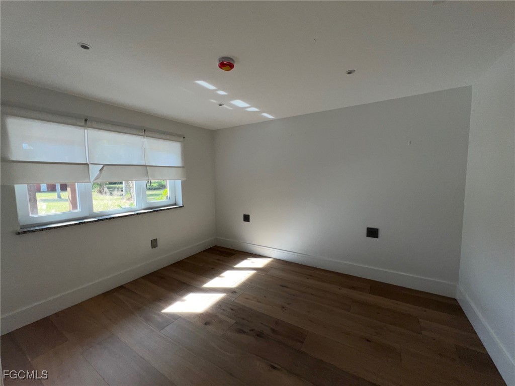 13191 Idylwild Farm Road Fort Myers, FL 33905 - Photo 8 of 21 an empty room with wooden floor and windows