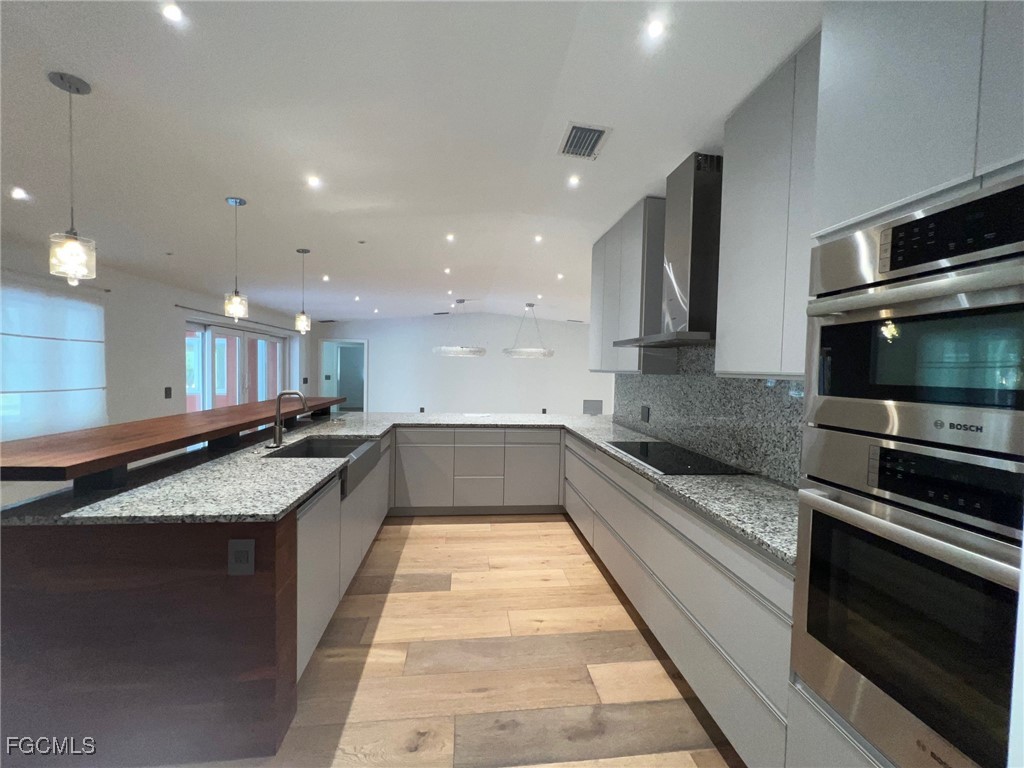 13191 Idylwild Farm Road Fort Myers, FL 33905 - Photo 10 of 21 a large kitchen with stainless steel appliances and a large counter top