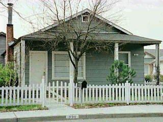 221 Middle Rincon Road Santa Rosa, CA 95409 - Photo 1 of 1 a view of a house with a small yard and wooden fence and wooden fence