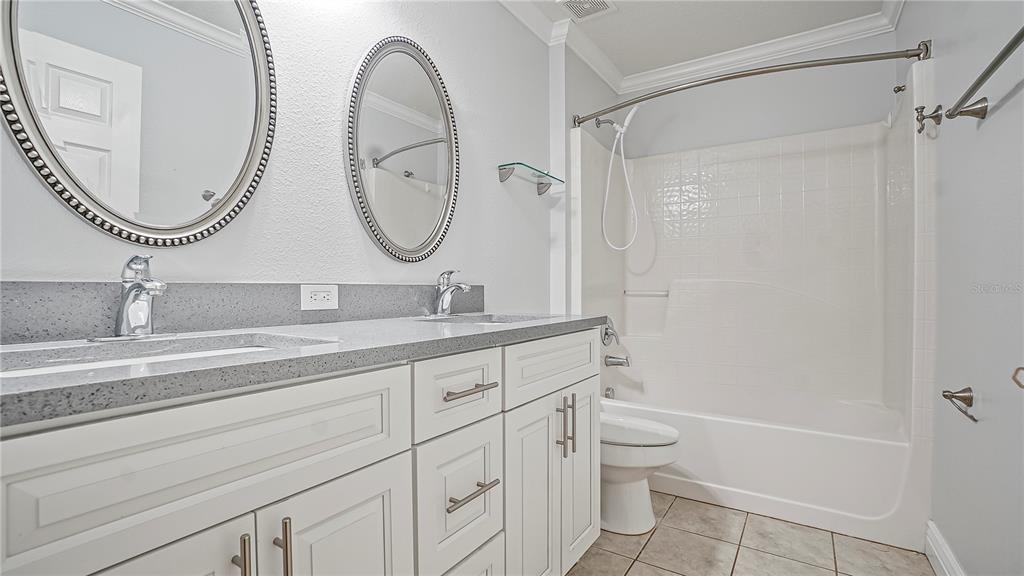 105 Caterham Way Kissimmee, FL 34758 - Photo 17 of 34 a bathroom with a granite countertop sink mirror toilet and a bathtub