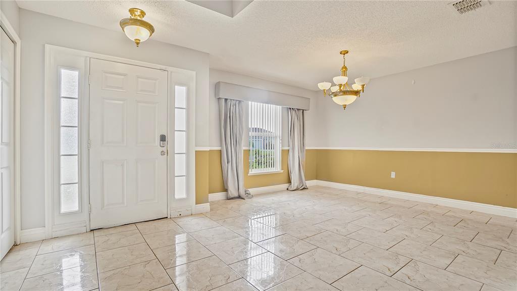 105 Caterham Way Kissimmee, FL 34758 - Photo 2 of 34 a view of an empty room with a window