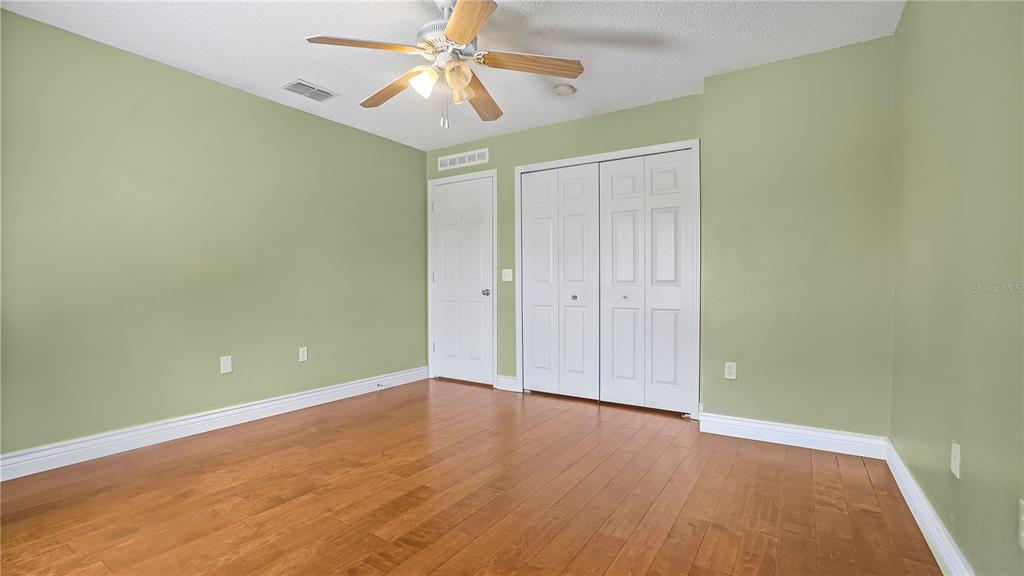 105 Caterham Way Kissimmee, FL 34758 - Photo 22 of 34 an empty room with a fan and a fan