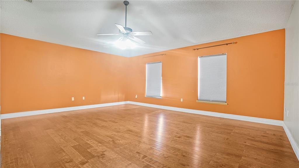105 Caterham Way Kissimmee, FL 34758 - Photo 23 of 34 a view of an empty room with chandelier and a window
