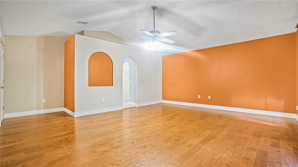 105 Caterham Way Kissimmee, FL 34758 - Photo 24 of 34 a view of an empty room with chandelier fan and a window