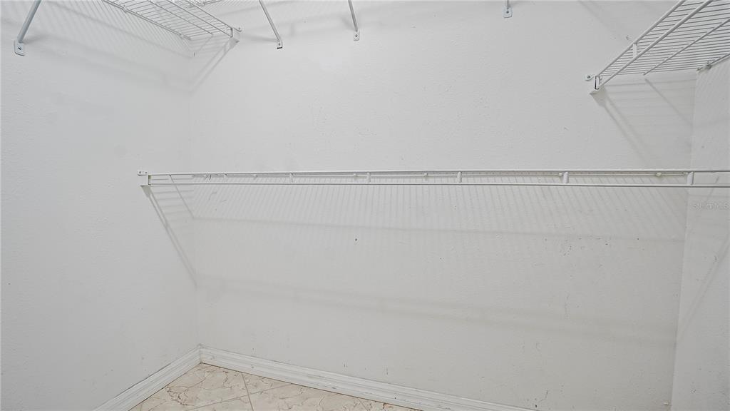 105 Caterham Way Kissimmee, FL 34758 - Photo 27 of 34 a view of a room with racks on the wall