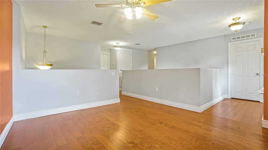 105 Caterham Way Kissimmee, FL 34758 - Photo 30 of 34 an empty room with wooden floor and windows