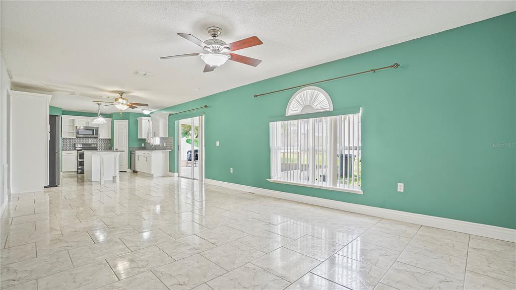 105 Caterham Way Kissimmee, FL 34758 - Photo 8 of 34 a view of a livingroom with a ceiling fan and window