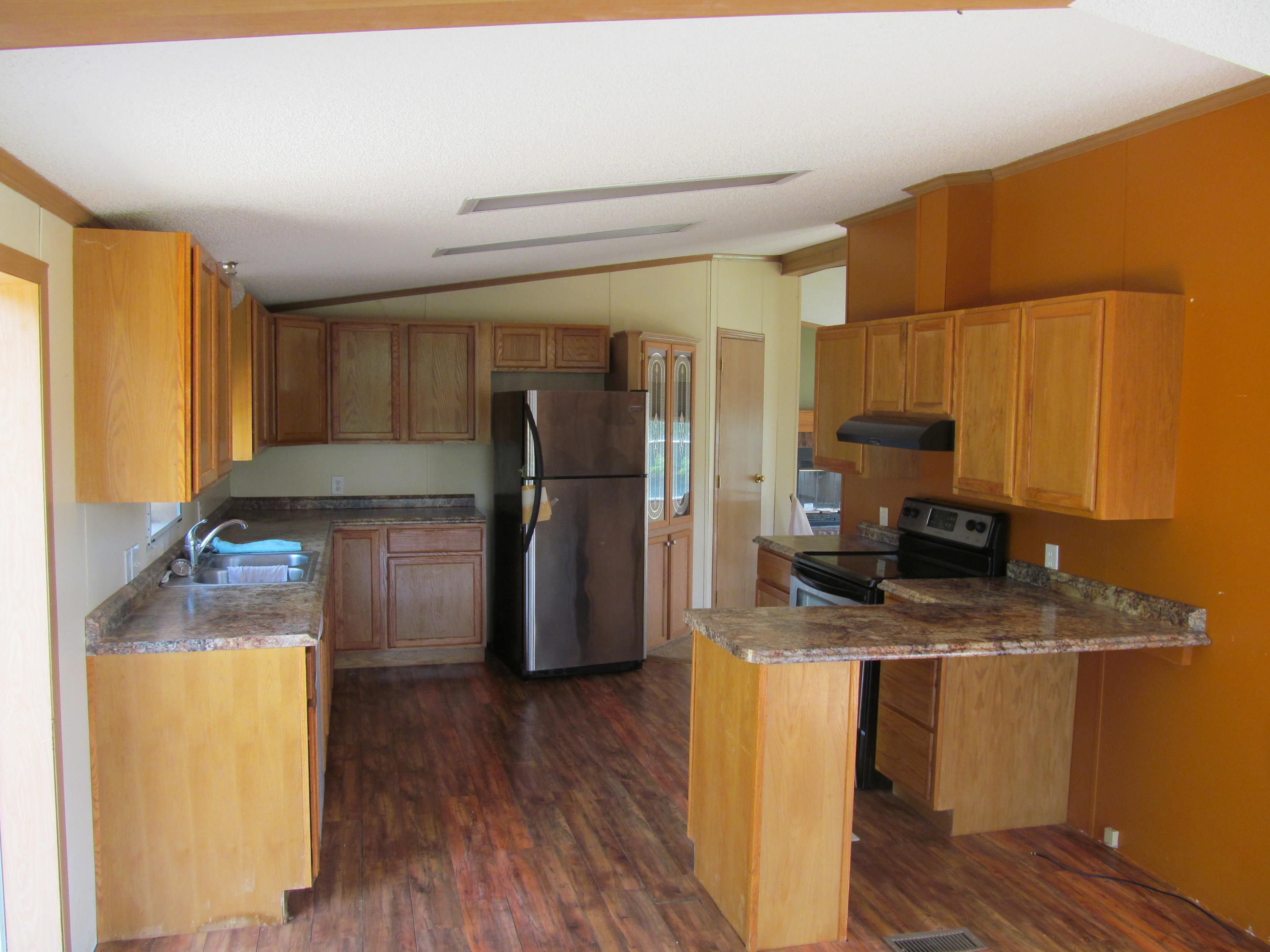 3016 Quarles Road Thaxton, VA 24174 - Photo 3 of 41 a kitchen with a refrigerator and a stove top oven