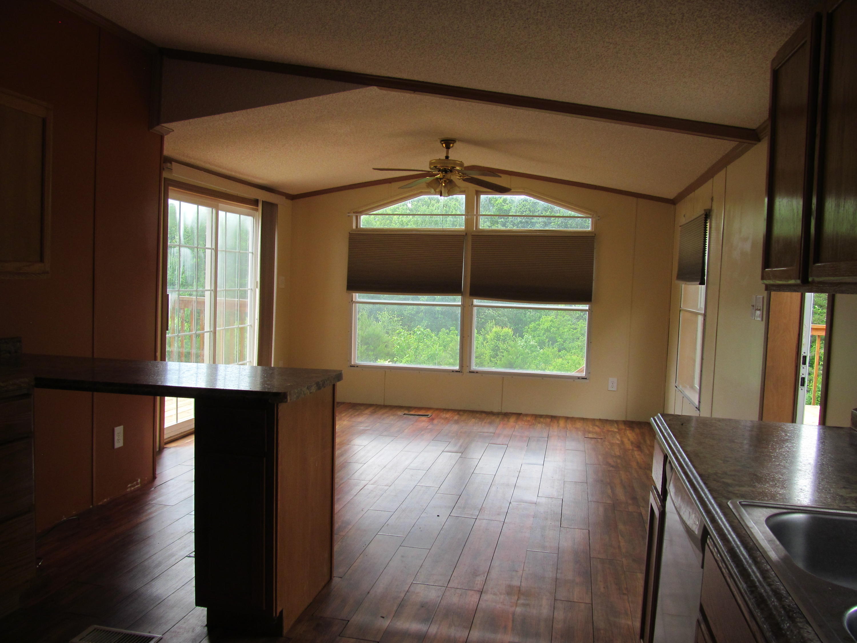 3016 Quarles Road Thaxton, VA 24174 - Photo 6 of 41 an empty room with wooden floor and windows
