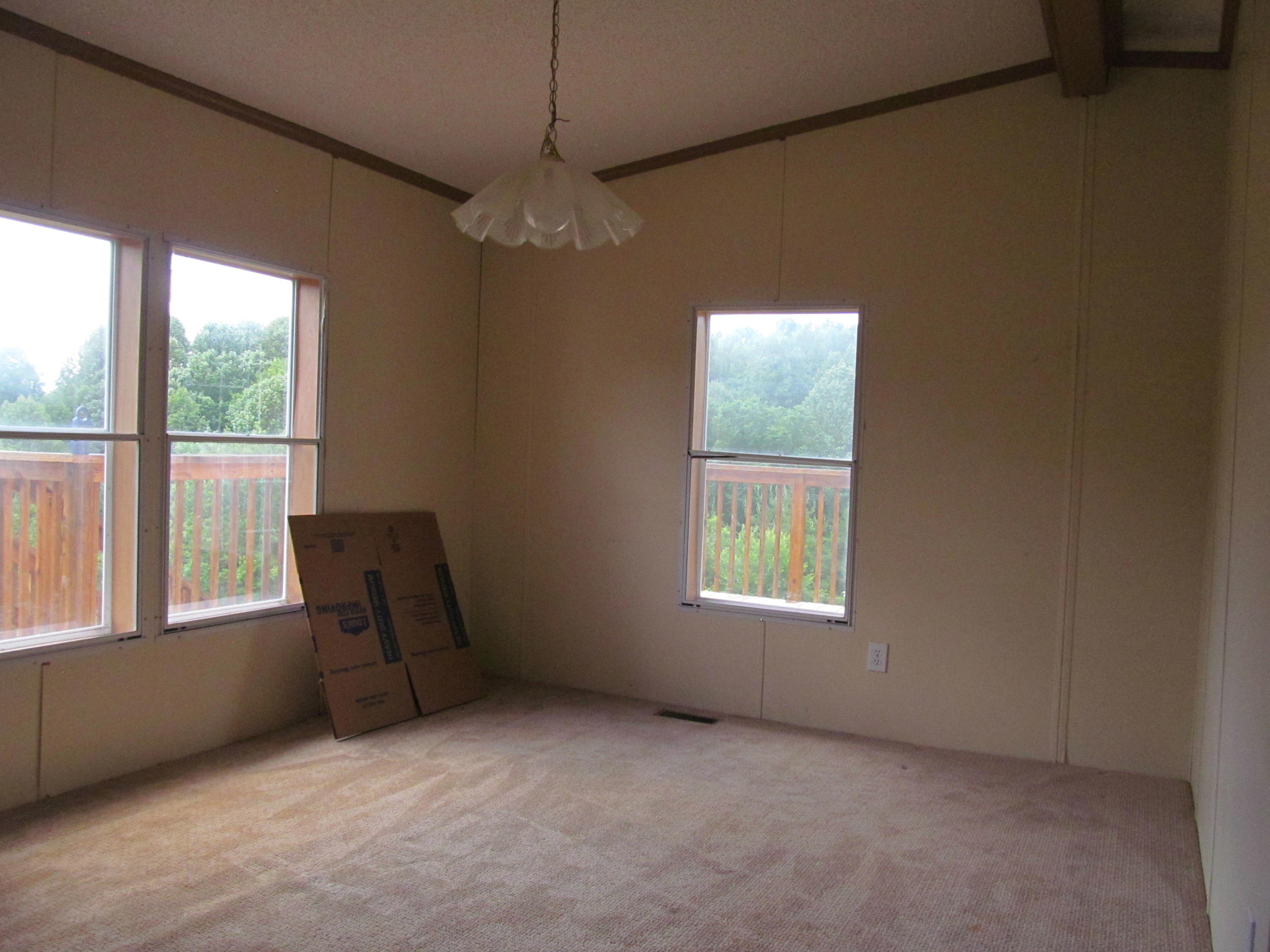3016 Quarles Road Thaxton, VA 24174 - Photo 7 of 41 an empty room with windows and ceiling fan