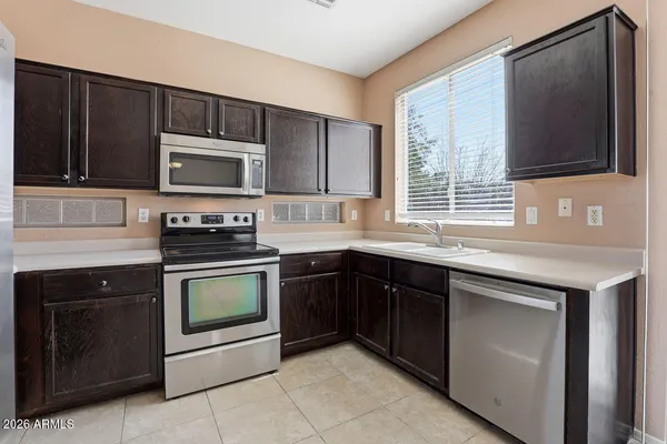 a kitchen with a refrigerator stove and sink