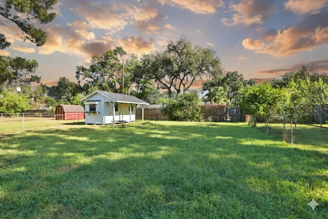 a front view of house with yard and green space