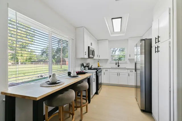 a kitchen with a sink stove and refrigerator
