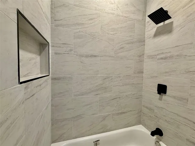 a bathroom with a shower and a toilet