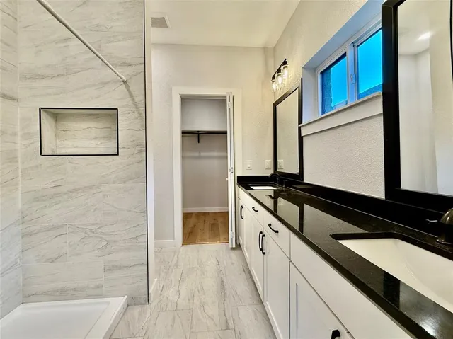 a kitchen with stainless steel appliances a refrigerator and a stove