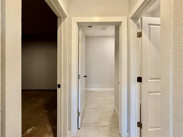 a view of a bathroom from a hallway
