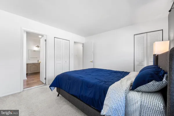 a bedroom with a bed and a lamp