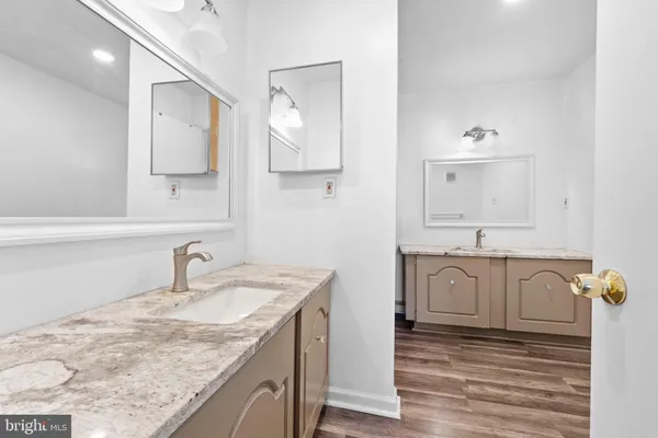 a bathroom with double sink and a mirror