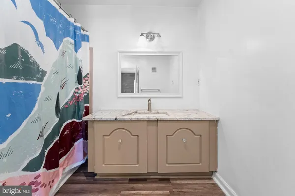 a spacious bathroom with a sink and a mirror