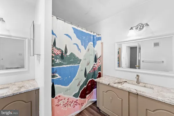 a bathroom with a granite countertop sink mirror and vanity