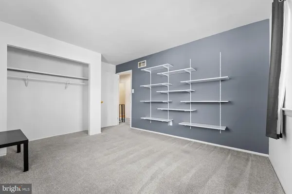 a view of an empty room with a closet