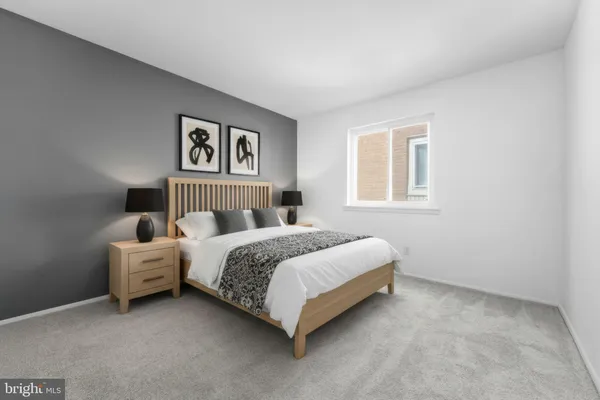 a spacious bedroom with a bed and a window