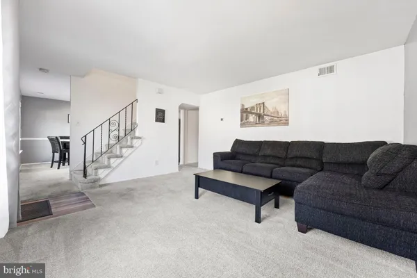 a living room with furniture and a ceiling fan