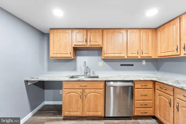 a kitchen with stainless steel appliances granite countertop a sink a stove and cabinets