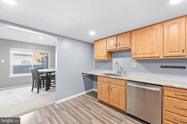 a kitchen with granite countertop a sink cabinets and window