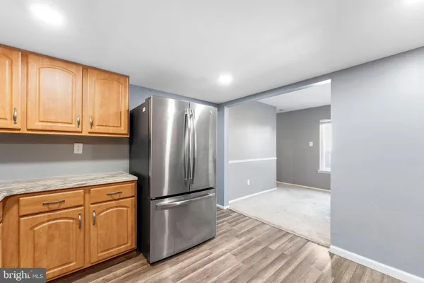 a kitchen with stainless steel appliances granite countertop a refrigerator and microwave
