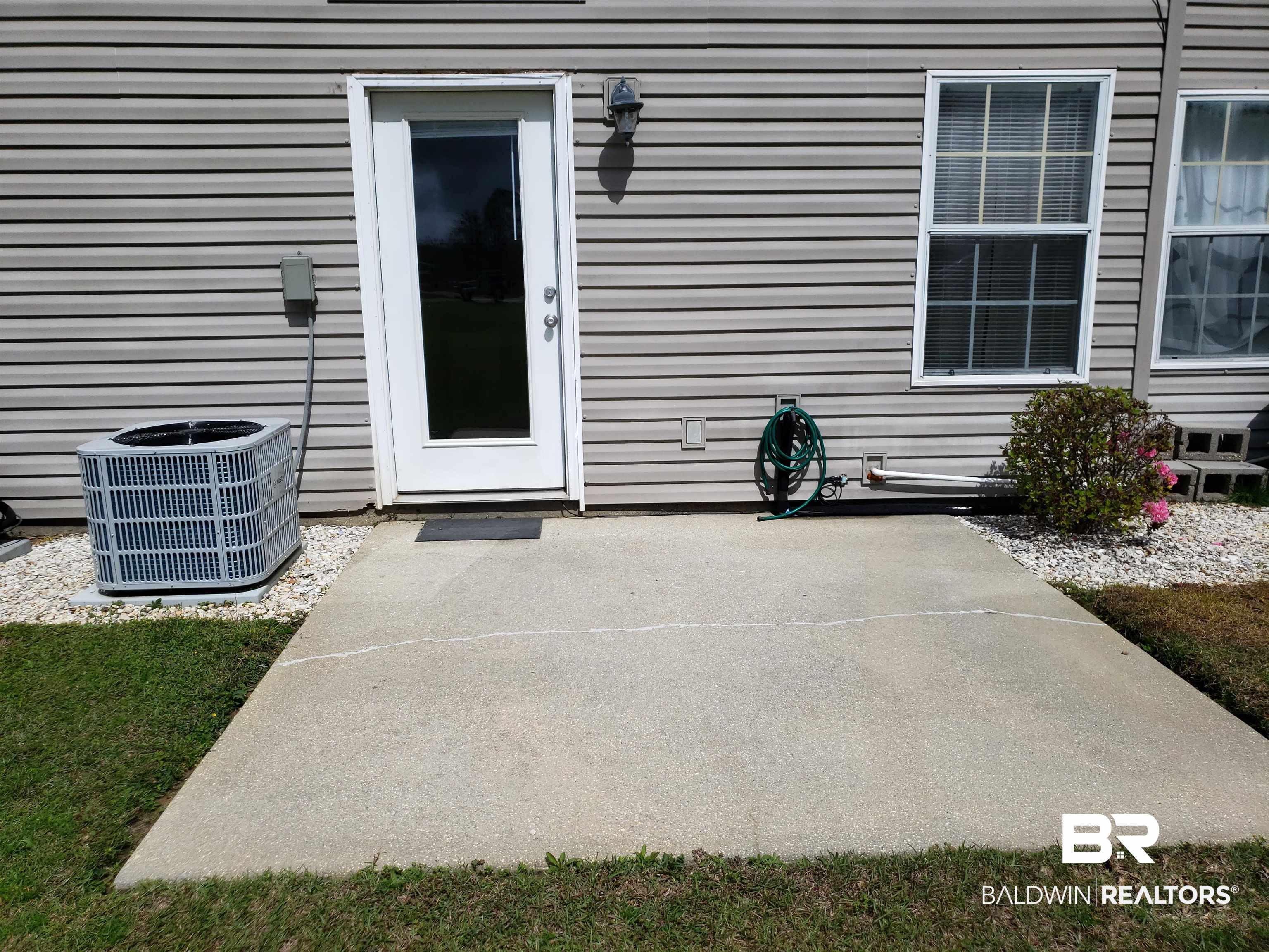 2006 Shelene Way, Unit 2006 Foley, AL 36535 - Photo 17 of 29 Rear entrance featuring a patio and central AC unit