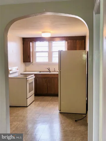 a bathroom with a sink a toilet a mirror and shower