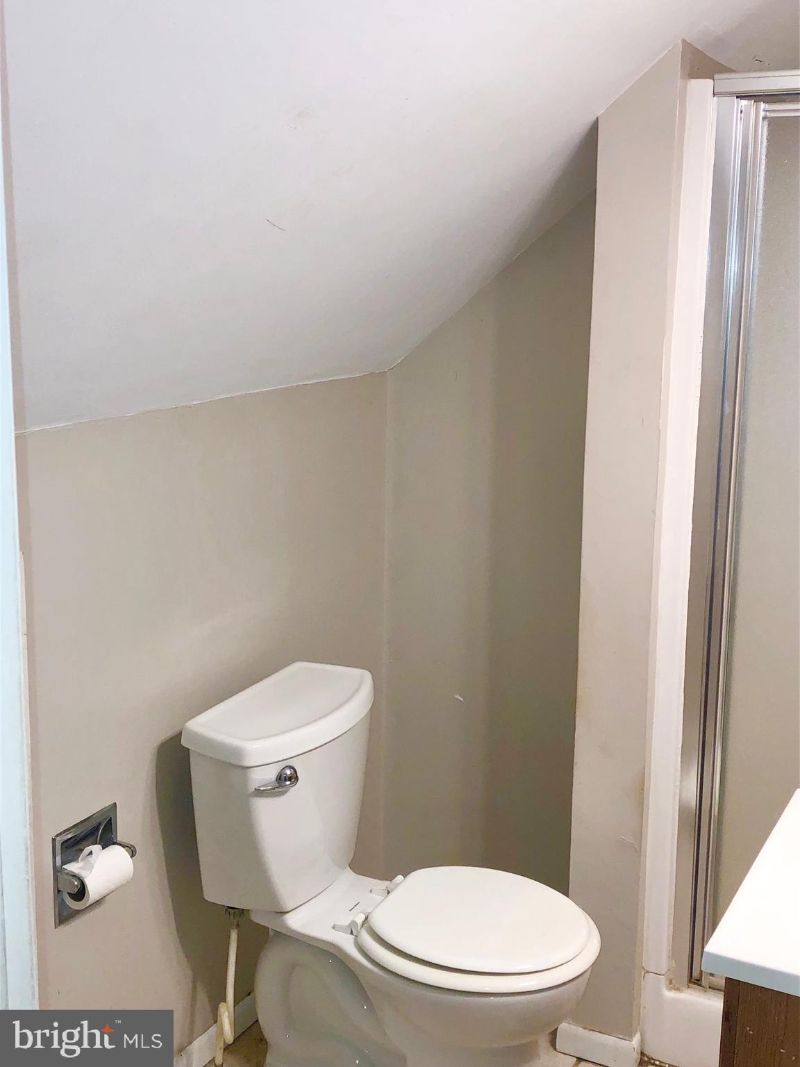 50 Dymond Avenue, Unit B Fayetteville, PA 17222 - Photo 9 of 23 a white toilet sitting next to a bathroom sink