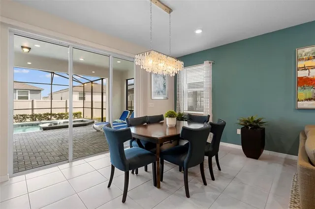 a view of a dining room with furniture and chandelier