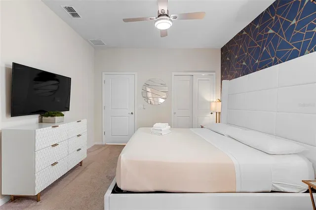 a bedroom with a bed and a chandelier