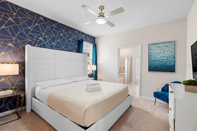 a spacious bathroom with a granite countertop sink mirror and a bathtub