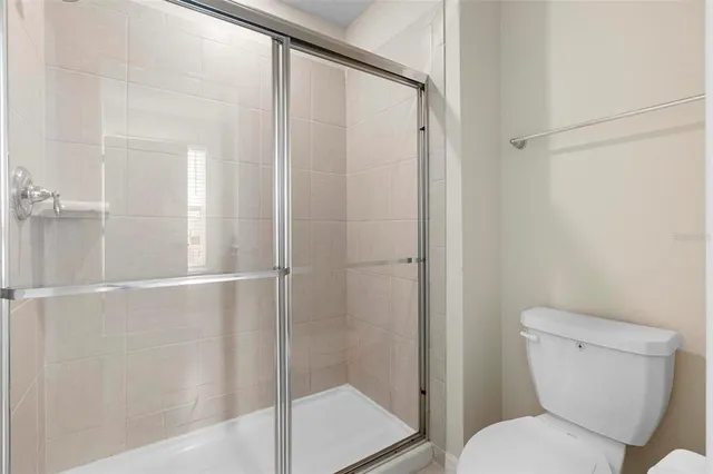 a bathroom with a granite countertop sink mirror and a bathtub