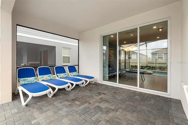 a living room with furniture a baby crib and a chair