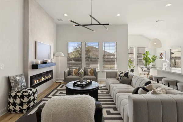 a living room with furniture and a floor to ceiling window