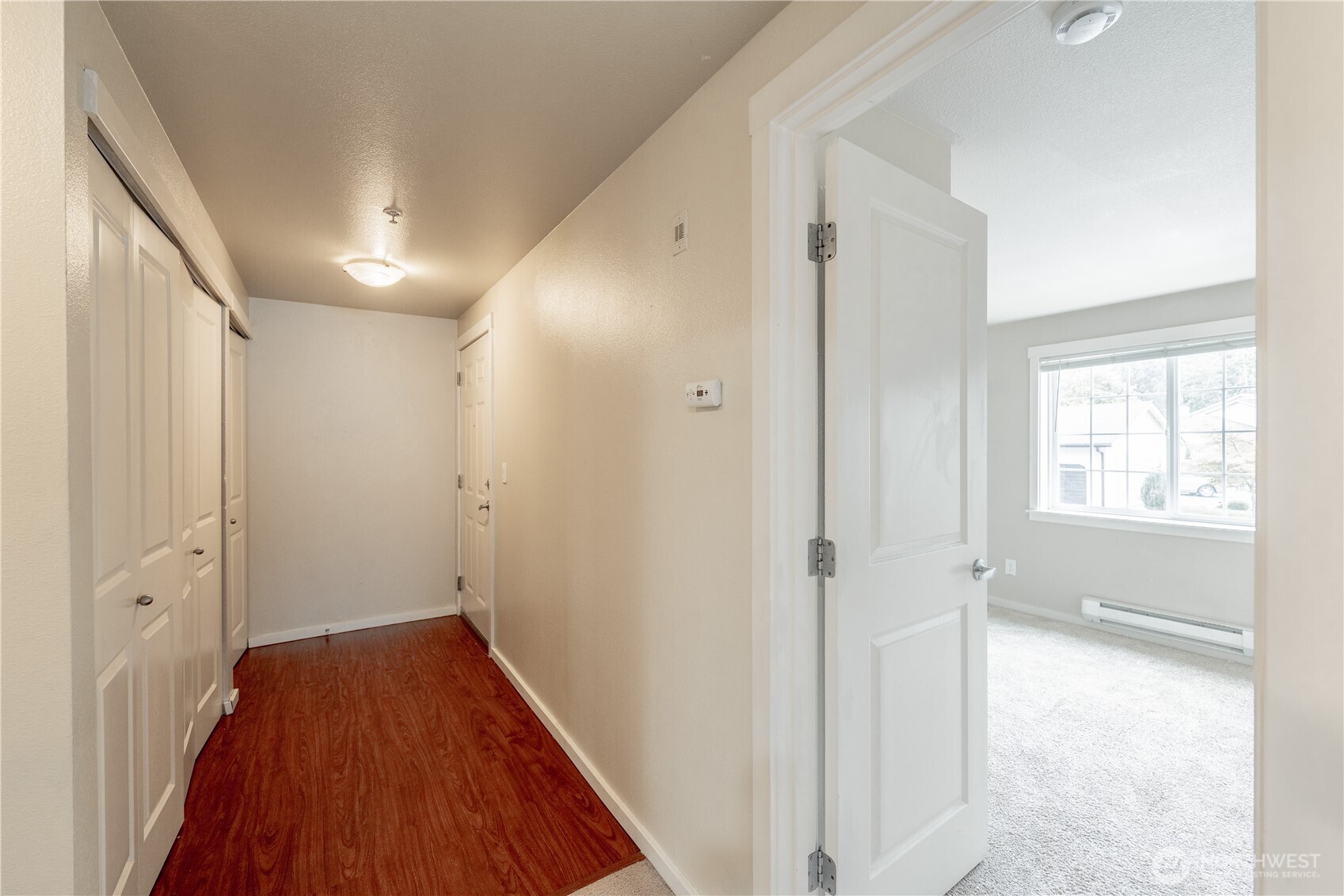 12404 East Gibson Road, Unit Q201 Everett, WA 98204 - Photo 15 of 40 a view of a hallway with wooden floor and a bathroom