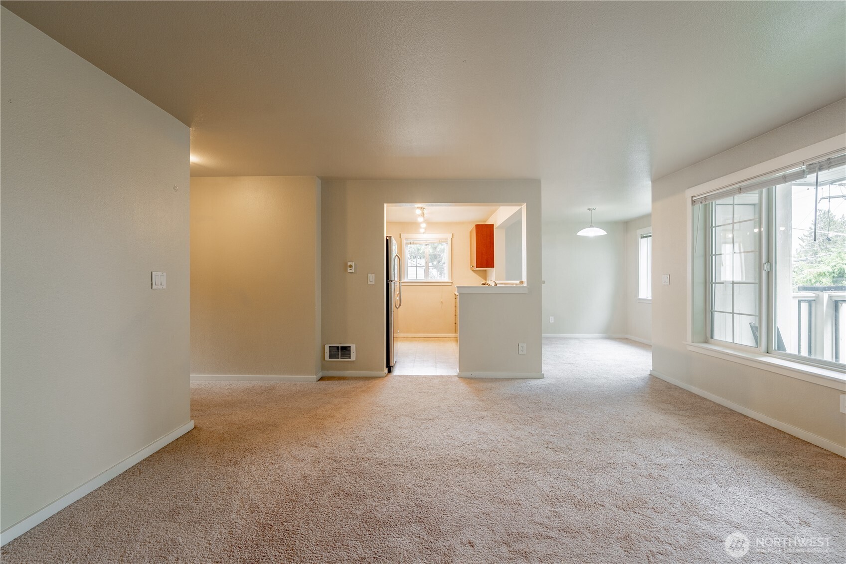 12404 East Gibson Road, Unit Q201 Everett, WA 98204 - Photo 28 of 40 an empty room with windows and view of kitchen