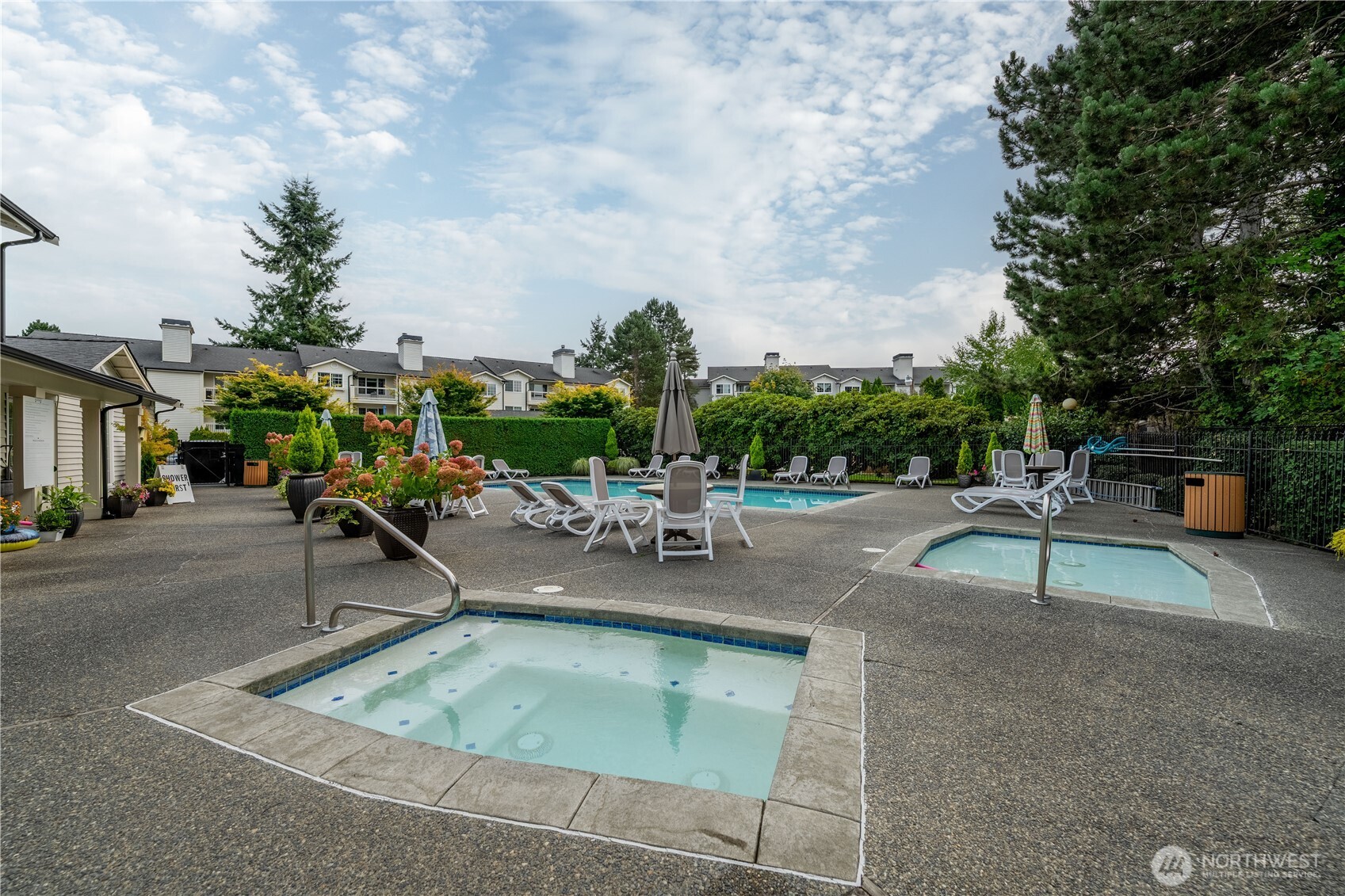 12404 East Gibson Road, Unit Q201 Everett, WA 98204 - Photo 35 of 40 a view of swimming pool with outdoor seating and plants
