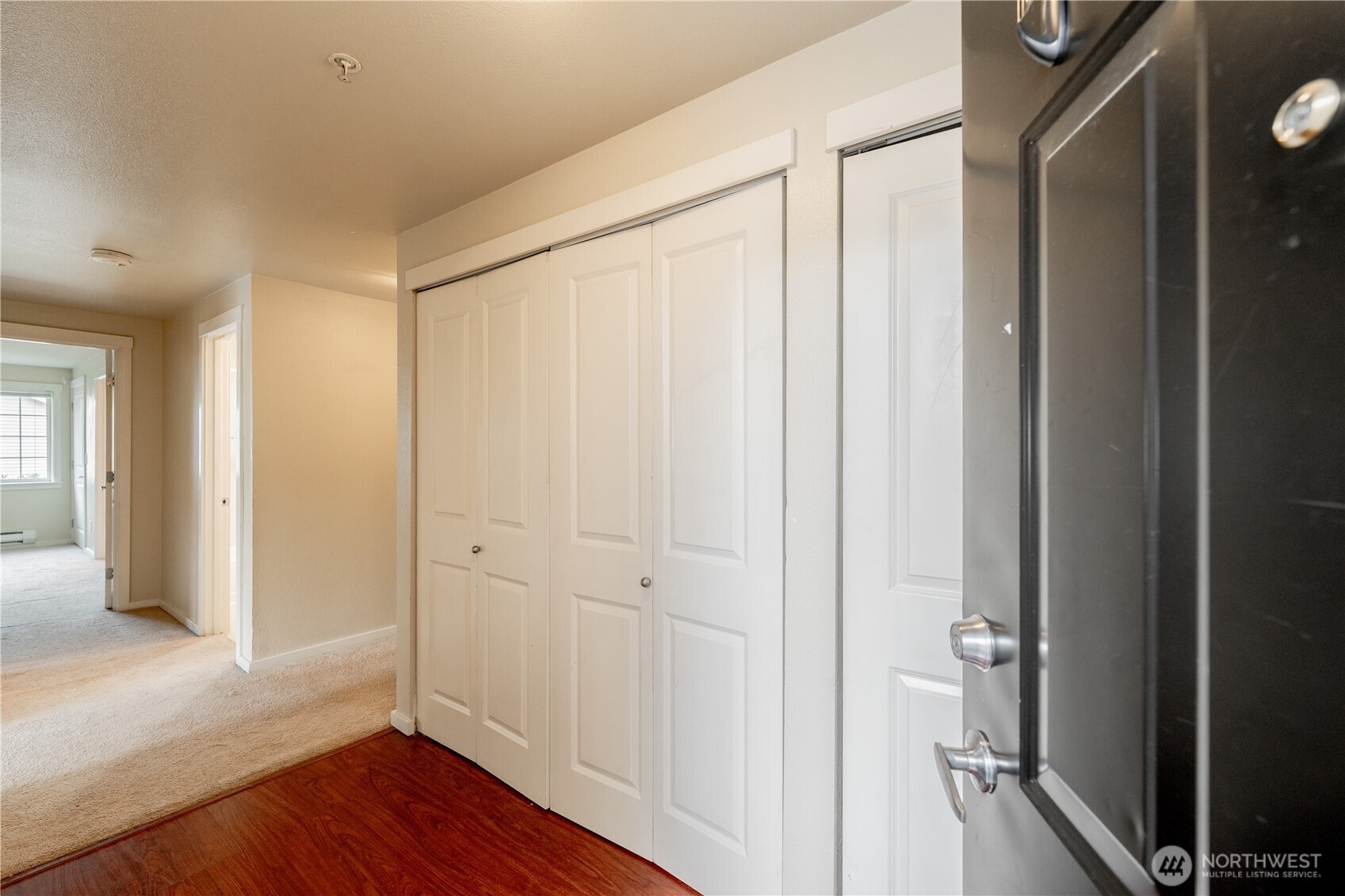 12404 East Gibson Road, Unit Q201 Everett, WA 98204 - Photo 5 of 40 a view of a hallway with wooden floor
