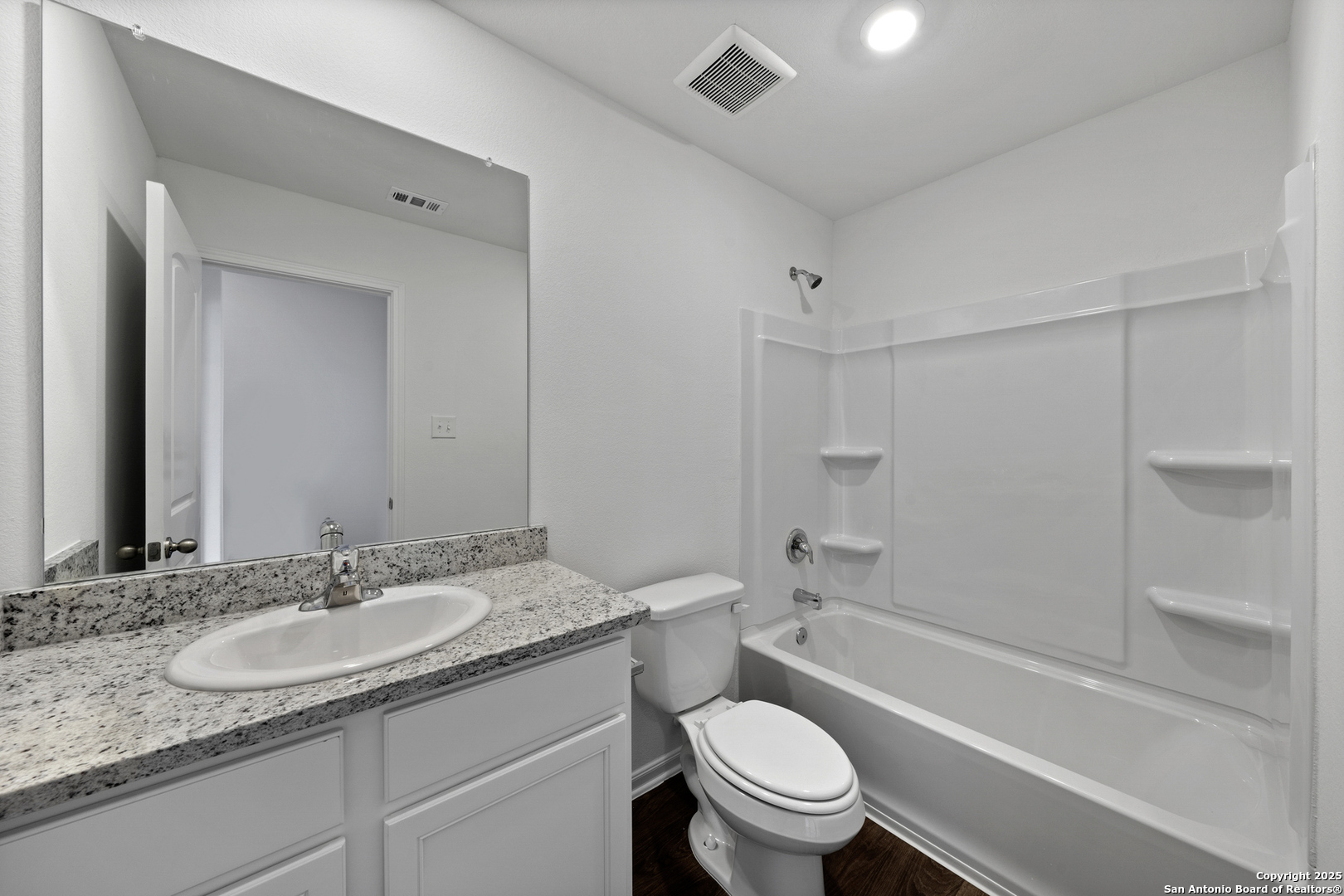 16004 Stratford Cove Lytle, TX 78052 - Photo 16 of 29 a bathroom with a granite countertop sink toilet and shower