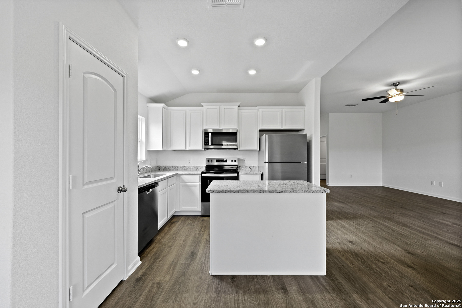 16004 Stratford Cove Lytle, TX 78052 - Photo 6 of 29 a kitchen with stainless steel appliances a refrigerator sink and microwave