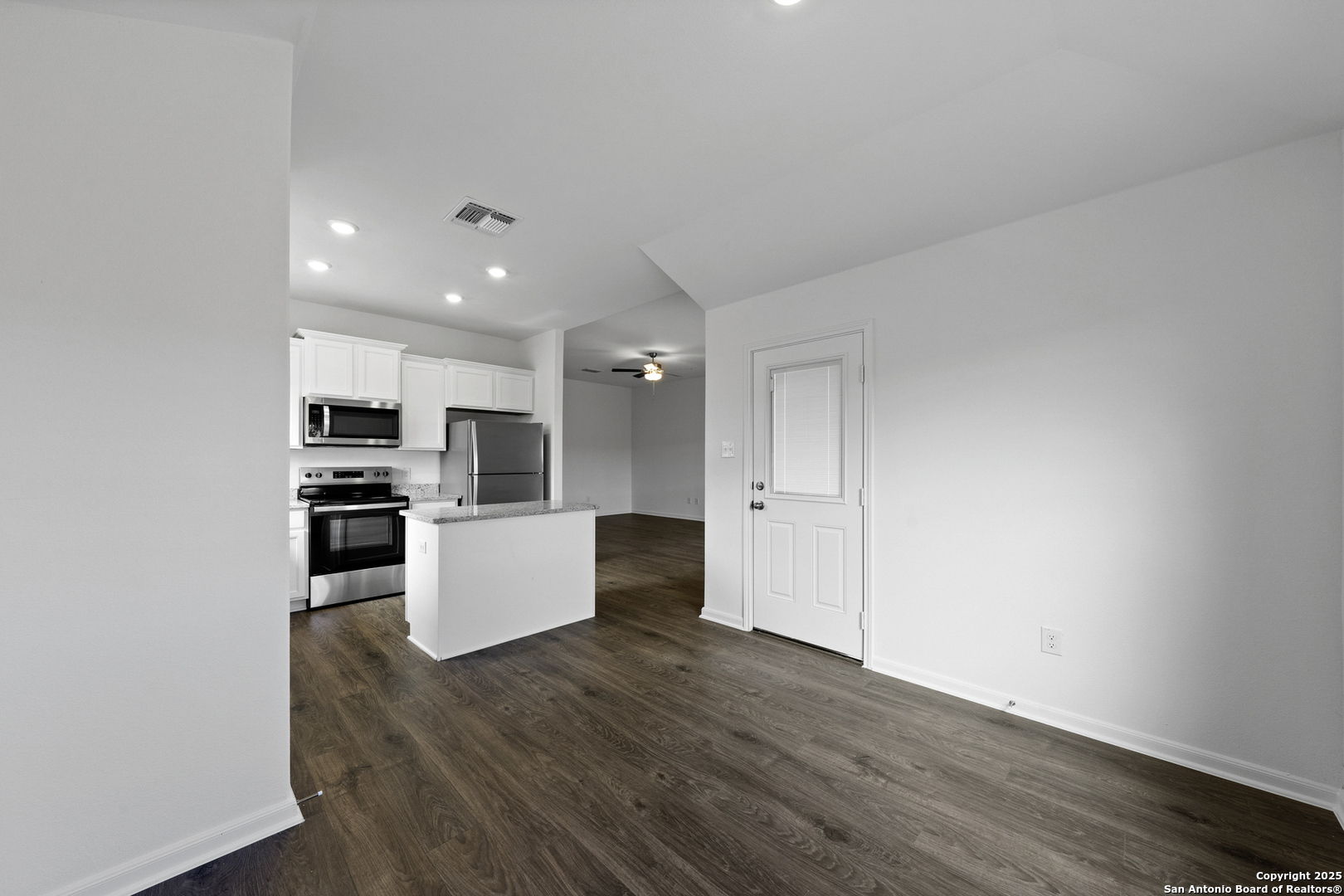 16004 Stratford Cove Lytle, TX 78052 - Photo 7 of 29 a view of kitchen with kitchen island stainless steel appliances cabinets and wooden floor