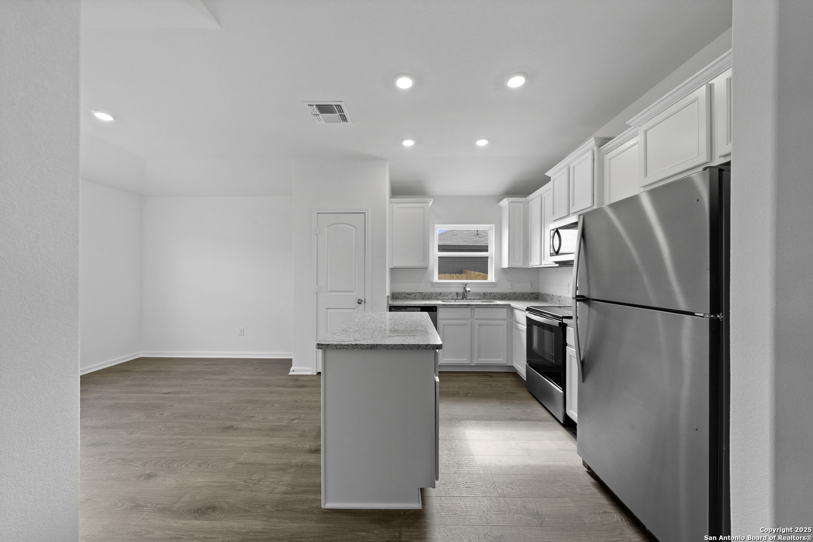 16004 Stratford Cove Lytle, TX 78052 - Photo 9 of 29 a kitchen with stainless steel appliances a refrigerator sink and microwave
