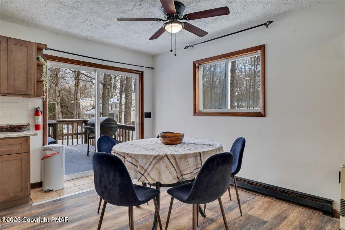 1662 Cotswald Road Tobyhanna, PA 18466 - Photo 11 of 43 a dining room with furniture a chandelier and wooden floor
